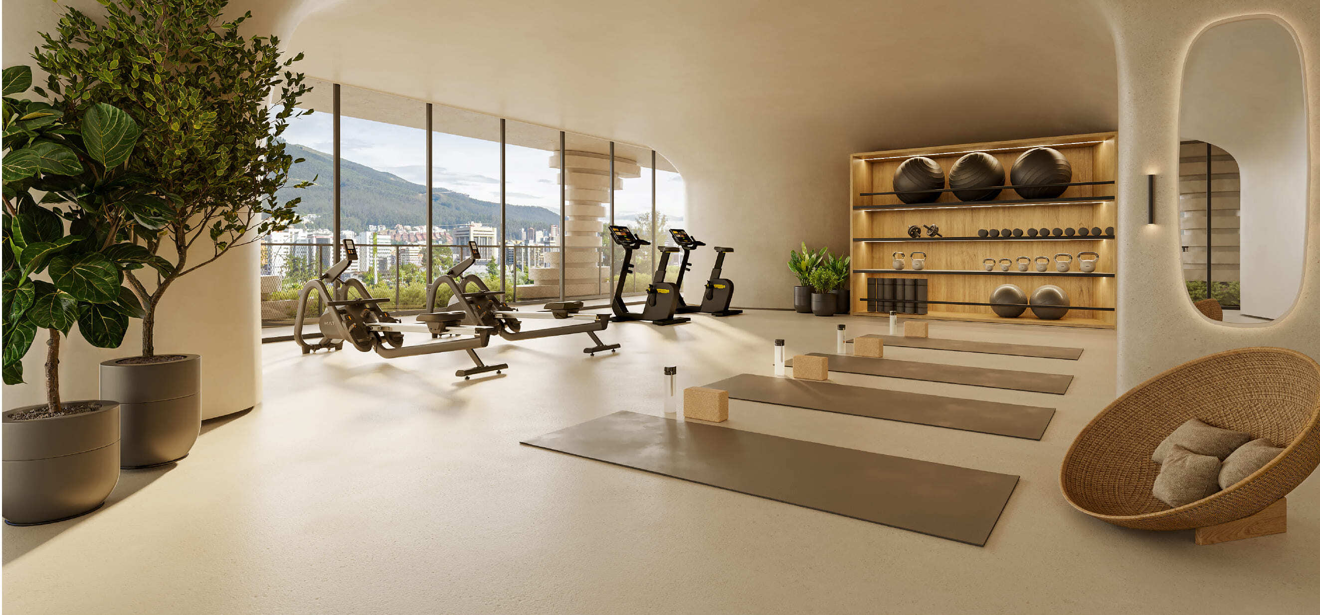Gimnasio equipado con bicicletas y sala de yoga con luz natural